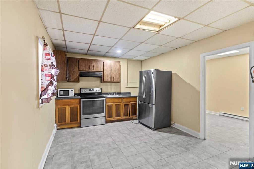 331 Market Street Paterson, NJ 07501 - Photo 7 of 25 a kitchen with stainless steel appliances granite countertop a refrigerator stove and sink
