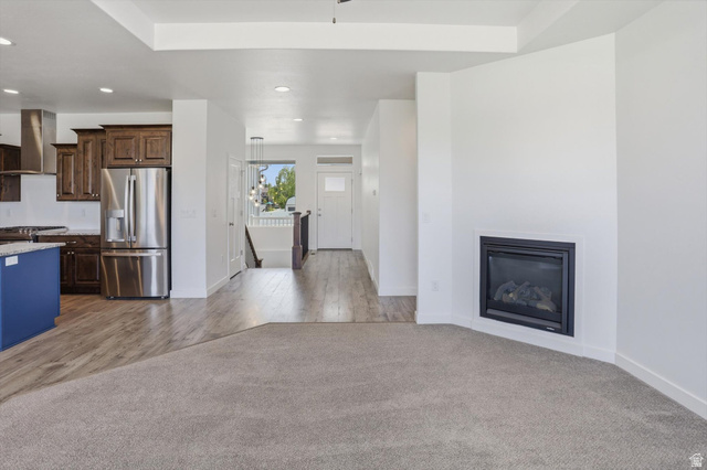 3636 West 910 South Syracuse, UT 84075 - Photo 42 of 70 Spacious open-concept living area featuring an inset fireplace, recessed lighting, and a tray ceiling