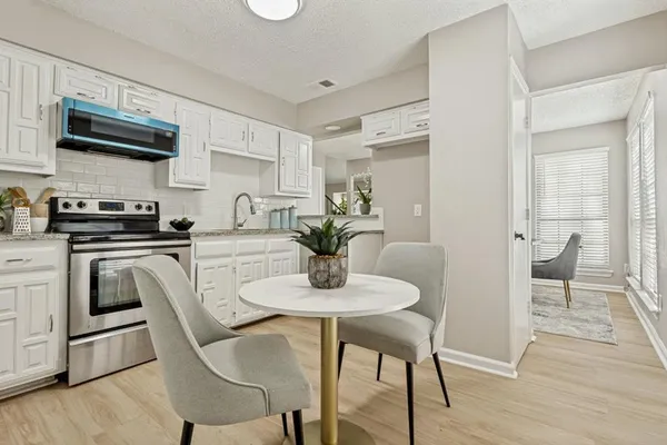 a dining room with furniture and wooden floor