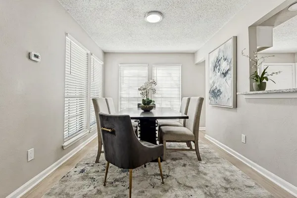a dining room with furniture a rug and wooden floor
