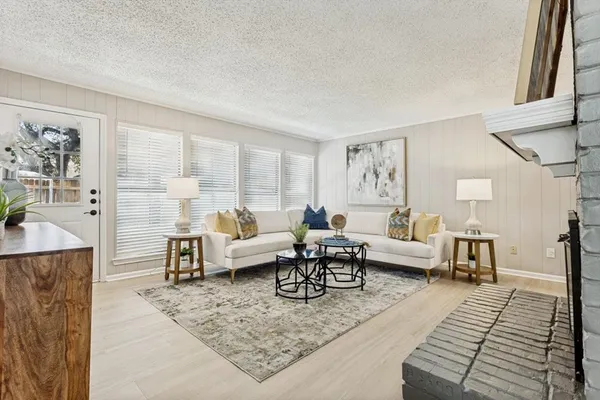 a living room with furniture wooden floor and a rug
