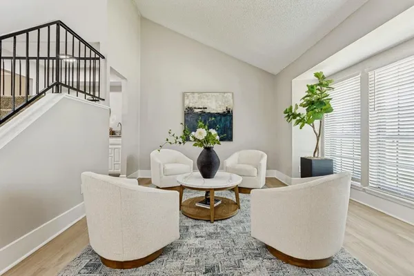 a living room with furniture and a potted plant