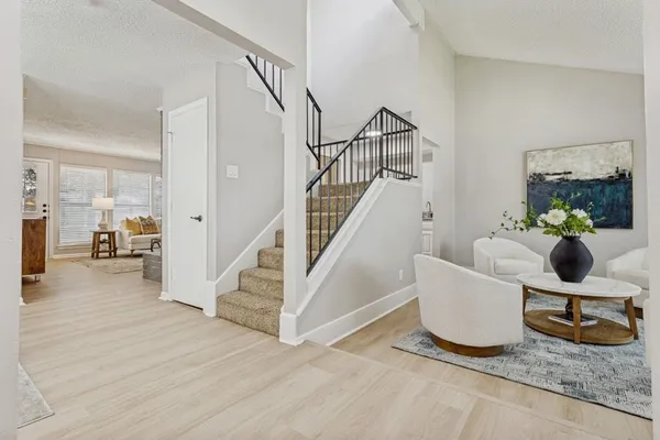 a living room with wooden floor and furniture