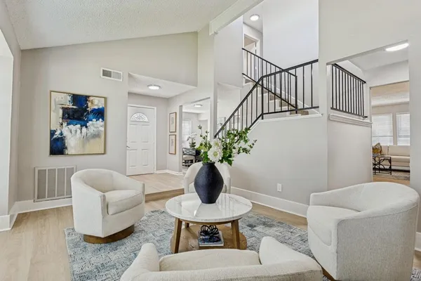 a living room with furniture and white walls