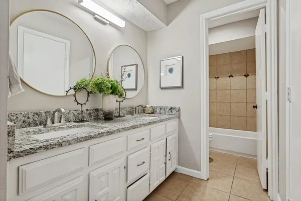 a bathroom with a double vanity sink and a mirror