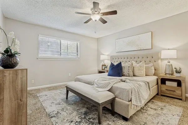 a bedroom with bed and a chandelier