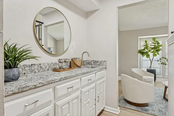 a bathroom with a granite countertop sink and mirror
