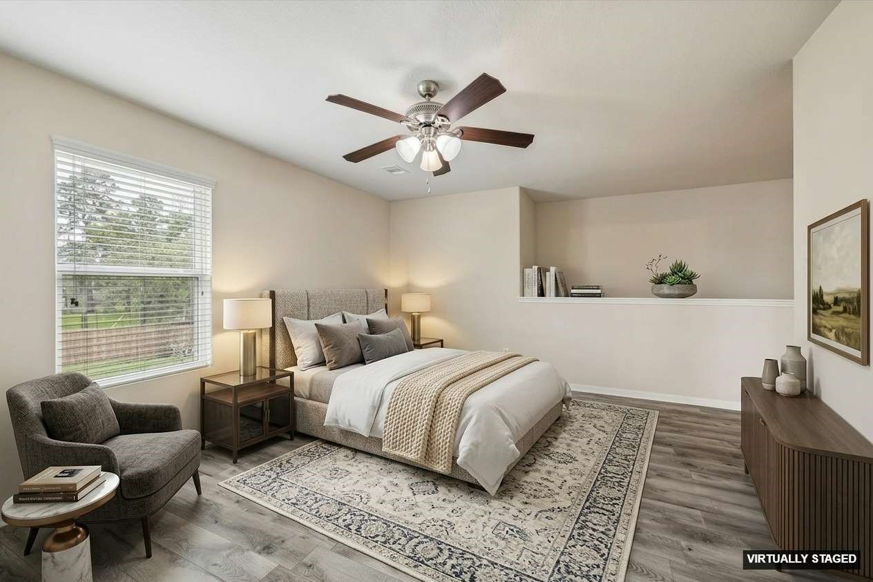 15642 South Fall Fern Circle Houston, TX 77044 - Photo 23 of 32 a bedroom with a bed and wooden floor