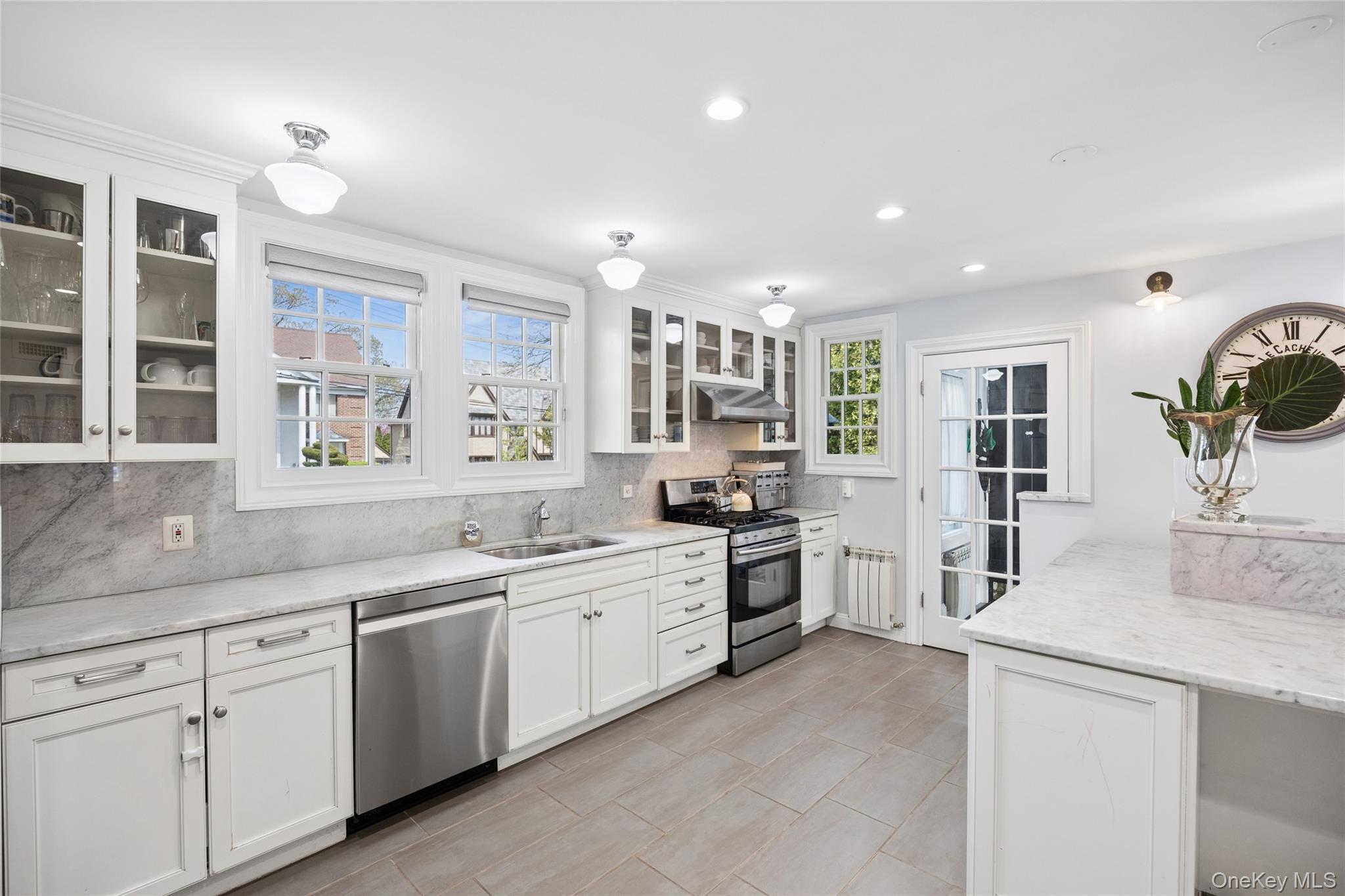 216 Beverly Road Queens, NY 11363 - Photo 5 of 50 a large kitchen with stainless steel appliances lots of counter space and a sink