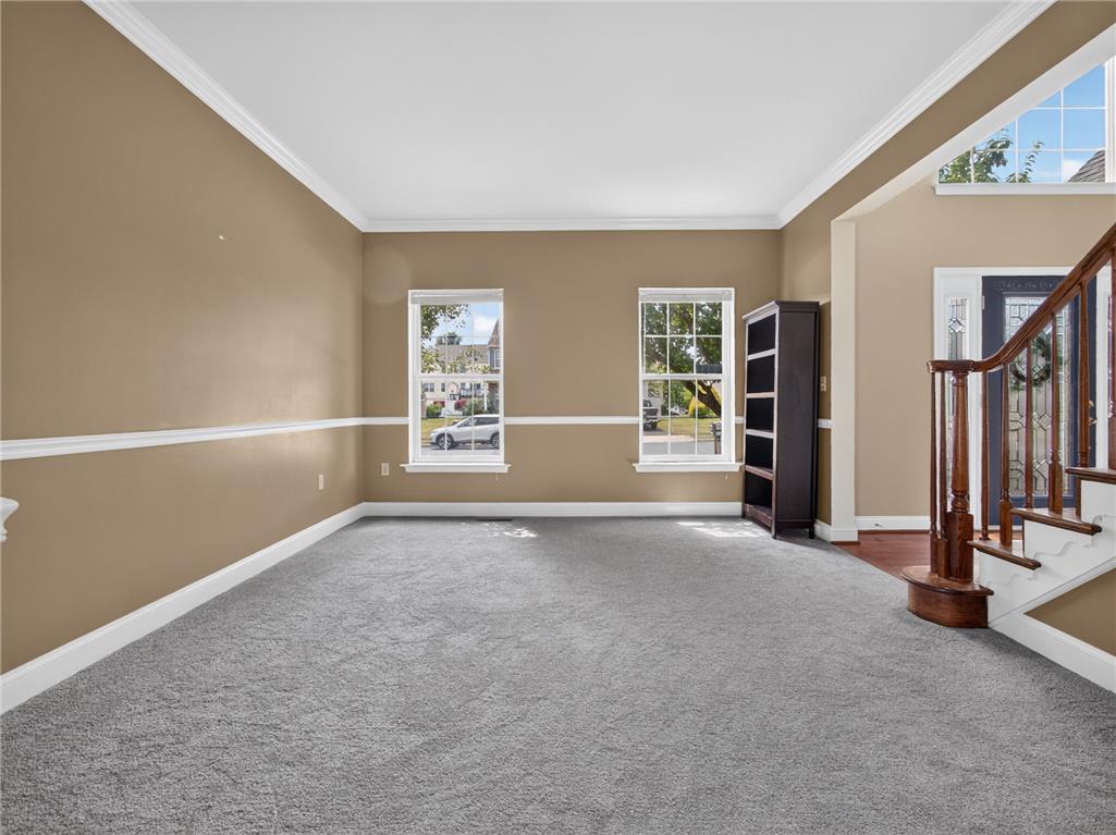 3821 Rittenhouse Road Lower Macungie Township, PA 18062 - Photo 20 of 62 A versatile front room boasts pristine carpeting and sun-filled windows, adjacent to an elegant staircase.