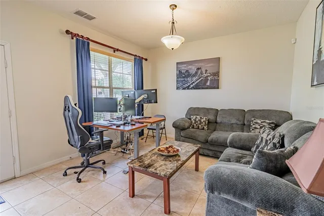 a living room with furniture a window and a chandelier