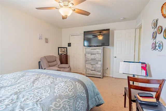 a bedroom with a bed and a television