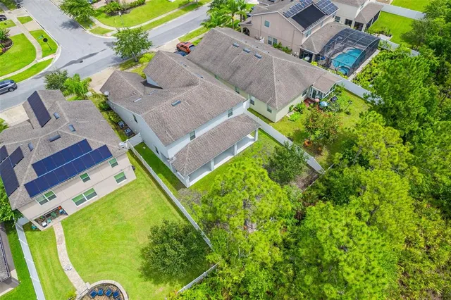 an aerial view of a house with a garden and swimming pool