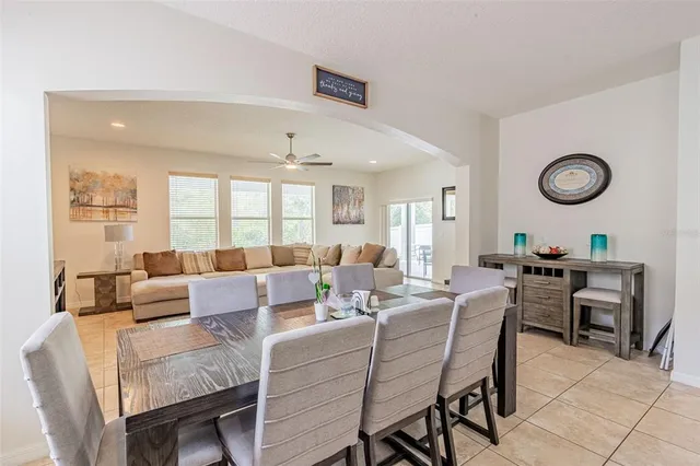 a living room with furniture a clock on wall and a window