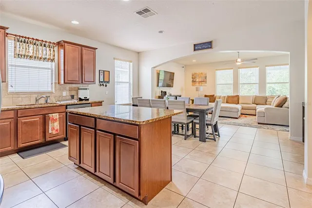 a large kitchen with lots of counter top and dining table