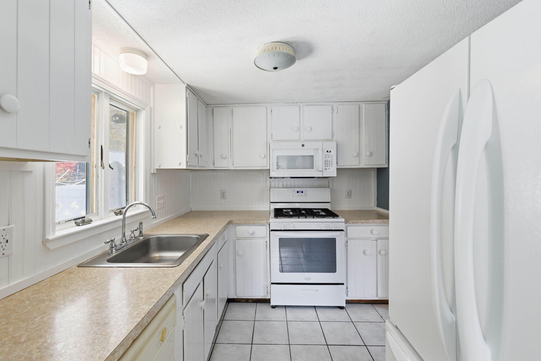 544 Cotuit Road Mashpee, MA 02649 - Photo 11 of 30 a kitchen with stainless steel appliances granite countertop a sink stove and refrigerator