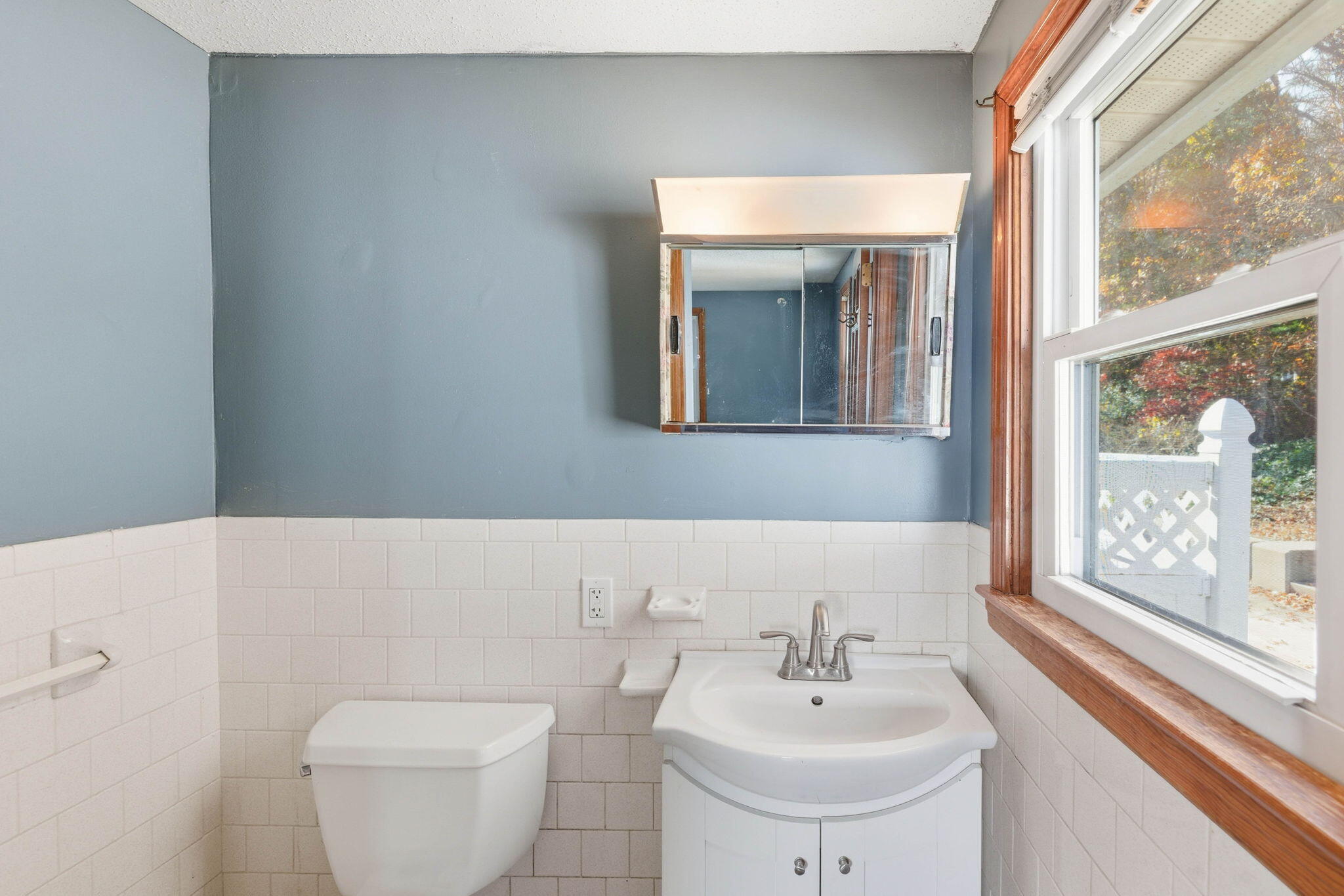 544 Cotuit Road Mashpee, MA 02649 - Photo 19 of 30 a bathroom with a toilet a sink and a large mirror