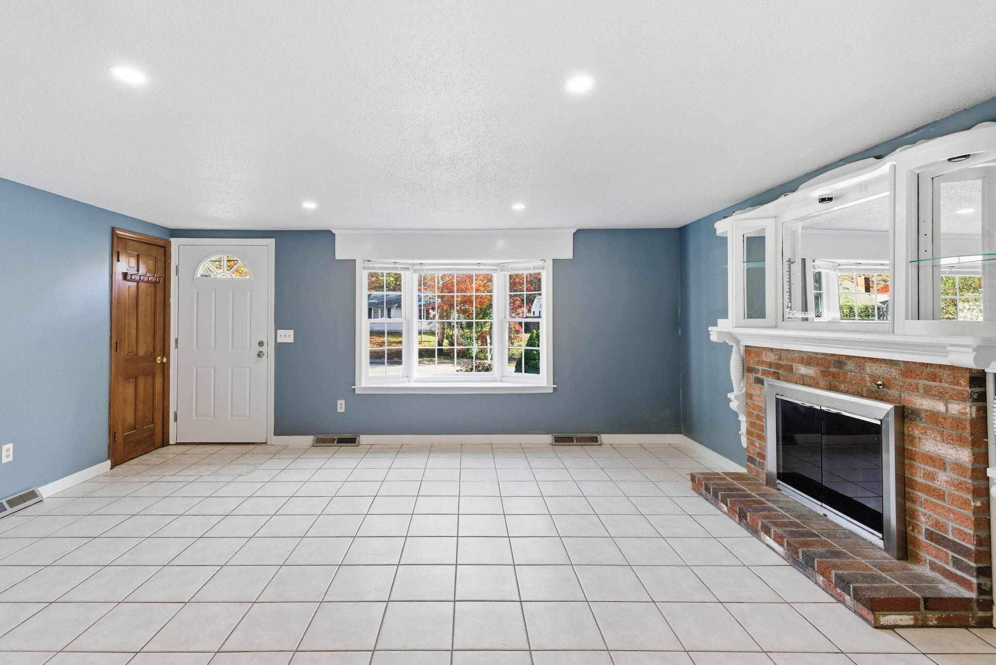 544 Cotuit Road Mashpee, MA 02649 - Photo 6 of 30 a view of an empty room with a fireplace and a window
