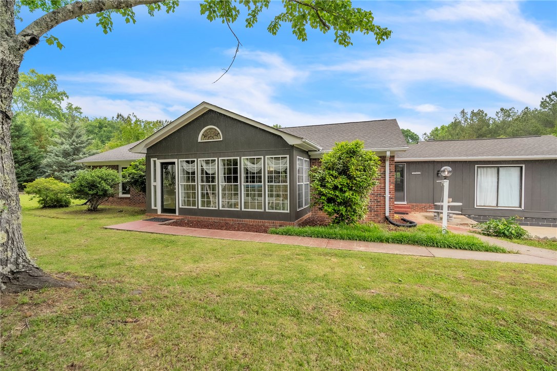 This charming home offers a serene escape with lush landscaping and a sun-drenched facade.