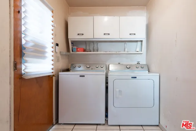 a view of cabinets with washer and dryer