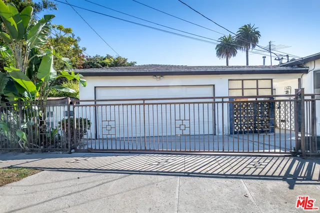 a view of a balcony with a potted plants and wooden fence