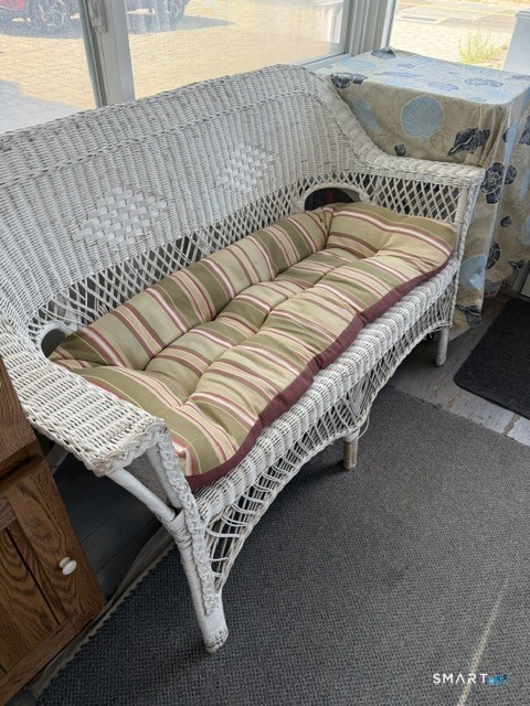 105 Shore Road Clinton, CT 06413 - Photo 19 of 19 Like this rattan settee in the rear enclosed porch, much of the furniture is available to the buyer OR will be removed by closing.