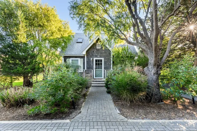 a front view of a house with garden