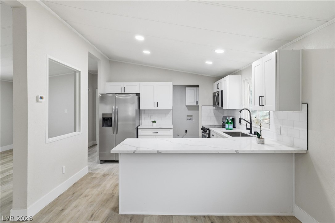 3940 Point Drive Pahrump, NV 89060 - Photo 13 of 35 A pristine culinary space boasts bright white cabinetry and gleaming stainless steel appliances.