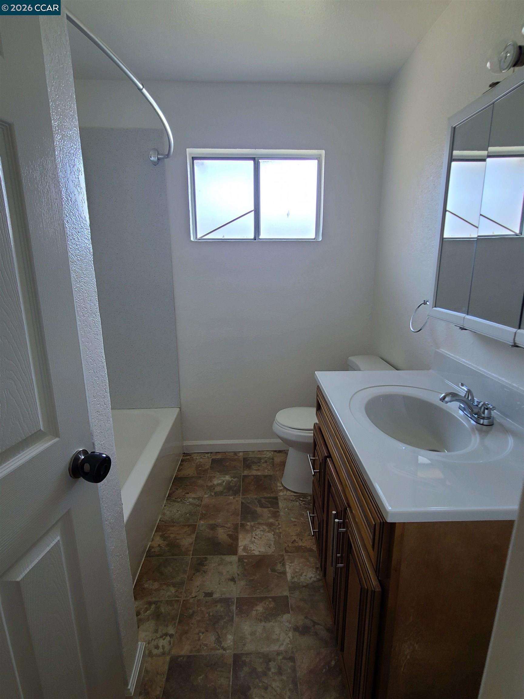 1906 Queens Road, Unit 8 Concord, CA 94519 - Photo 4 of 6 a bathroom with a sink toilet and shower