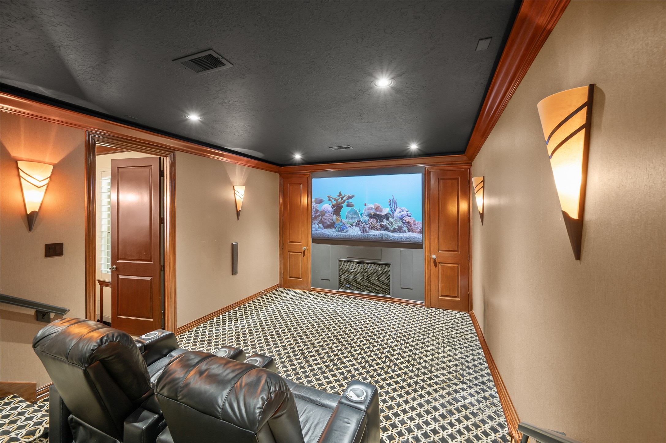 2127 Thicket Ridge Lane Houston, TX 77077 - Photo 18 of 48 The ultimate entertainment hub: experience true immersion with an expansive 101" screen and the unparalleled convenience of direct poolside bath access for effortless transition from movie nights to late-night swims.