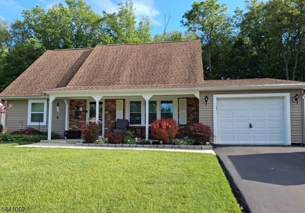 a view of a house with sitting area and garden