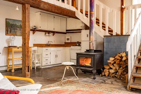 a backyard of a house with barbeque oven table and chairs