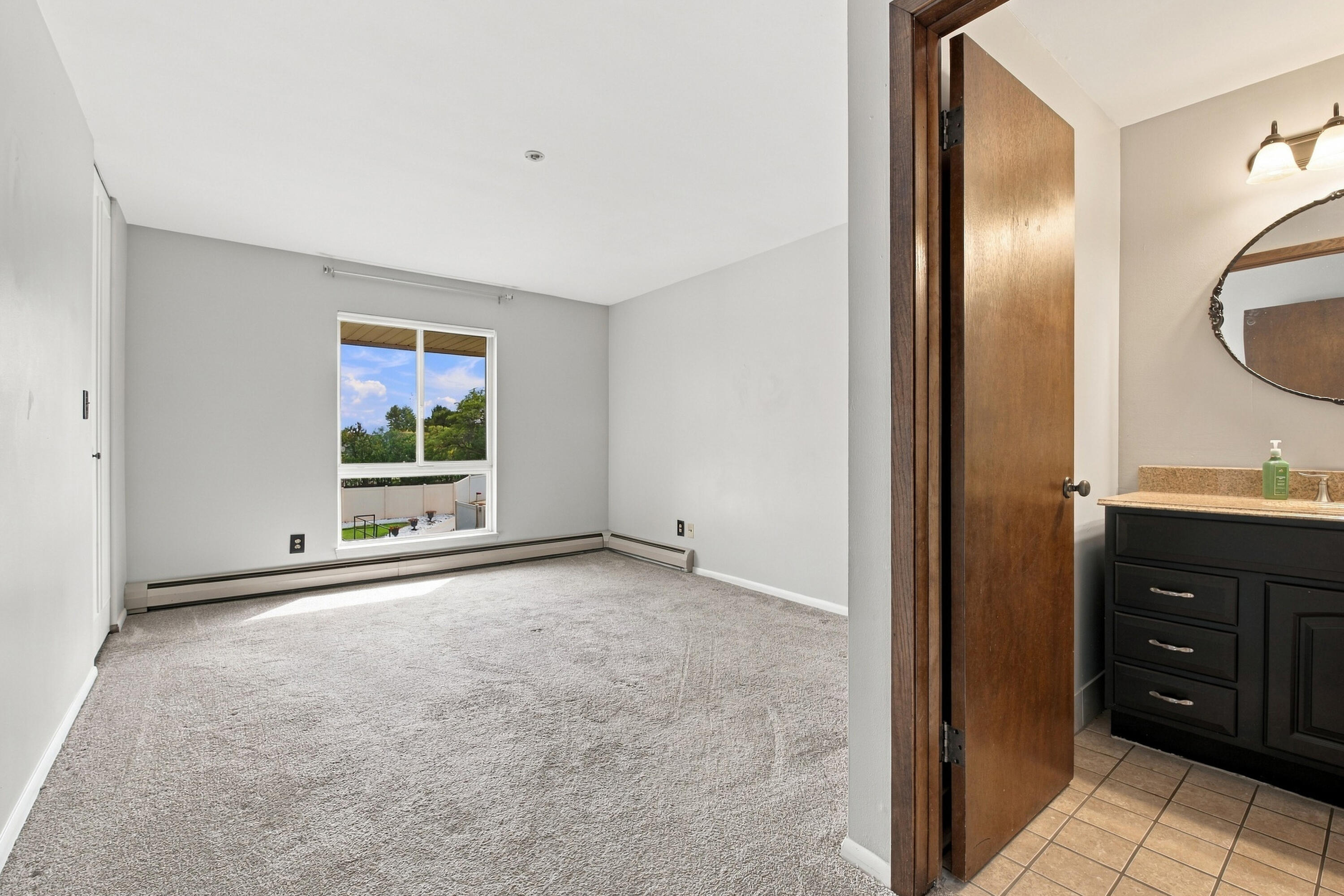 4117 West Rivers Edge Circle, Unit 13 Brown Deer, WI 53209 - Photo 11 of 28 Primary Bedroom half bath