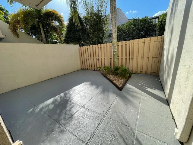 a view of a house with a yard and potted plants