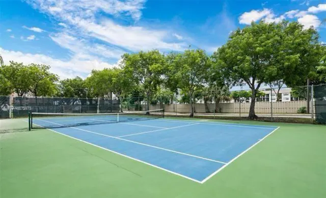 a view of a patio with a table and chairs under an umbrella
