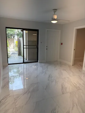 an empty room with windows and closet