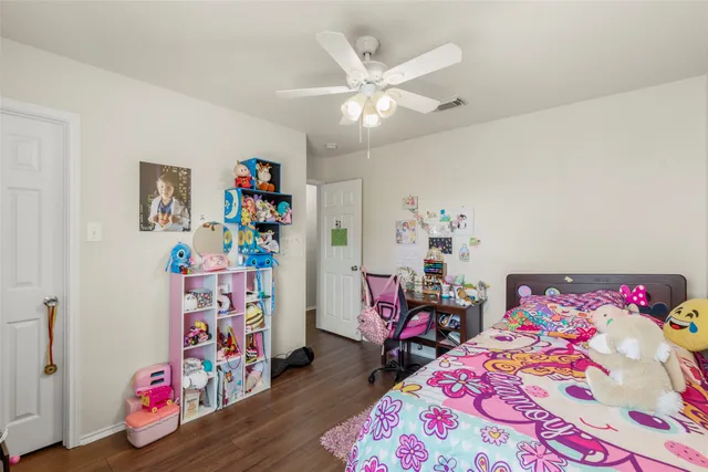 a bed room with a bed and a chair