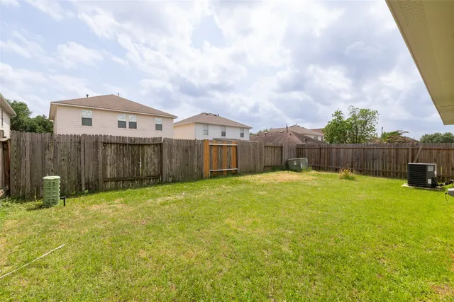 a view of a backyard with wooden fence
