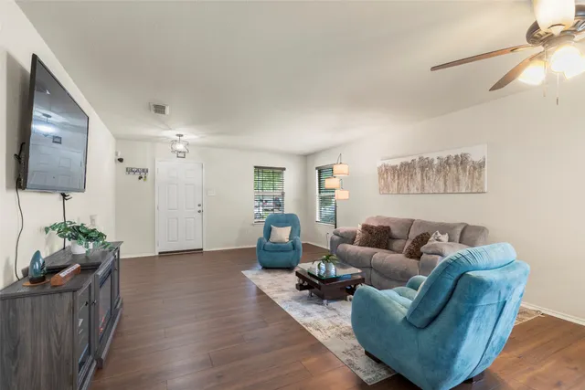 a living room with furniture and wooden floor