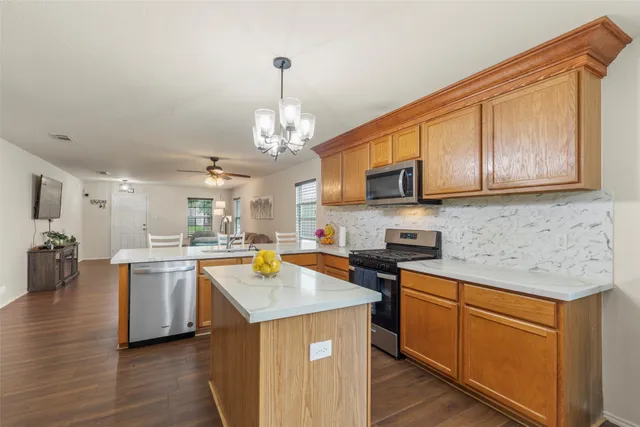 a kitchen with a sink stove and microwave