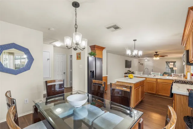 a large kitchen with a table and chairs