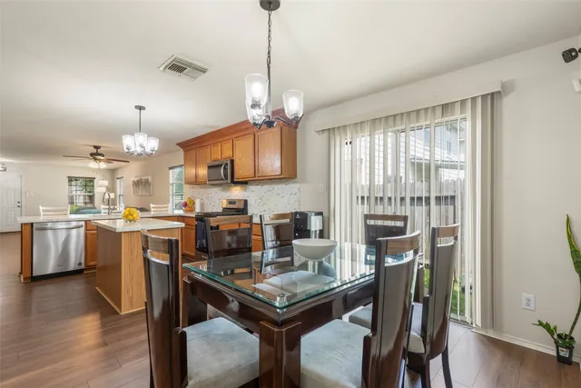 a view of a dining room with furniture window and wooden floor