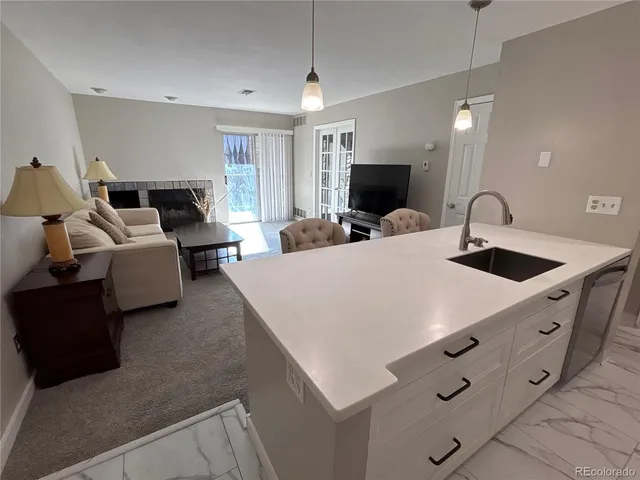 a large bedroom with bed and a flat tv screen on dresser