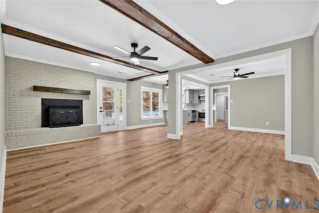 a view of an empty room with a fireplace and a window