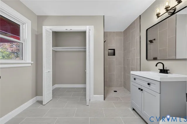 a spacious bathroom with a mirror sink and shower