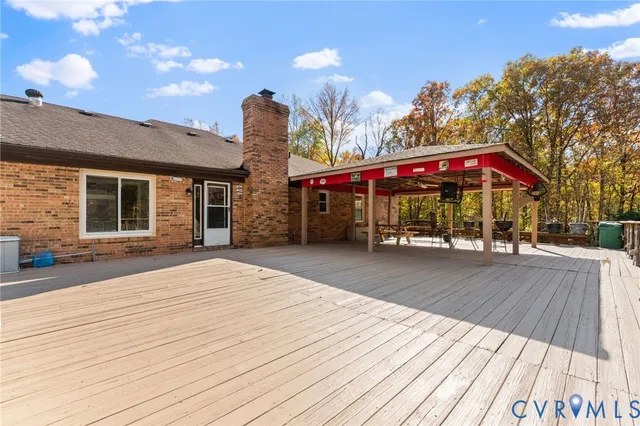 a view of a rooftop deck with couch and chairs
