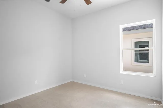 an empty room with a window and fireplace