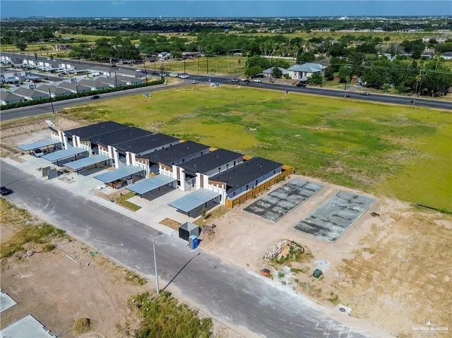 an aerial view of residential houses with swimming pool