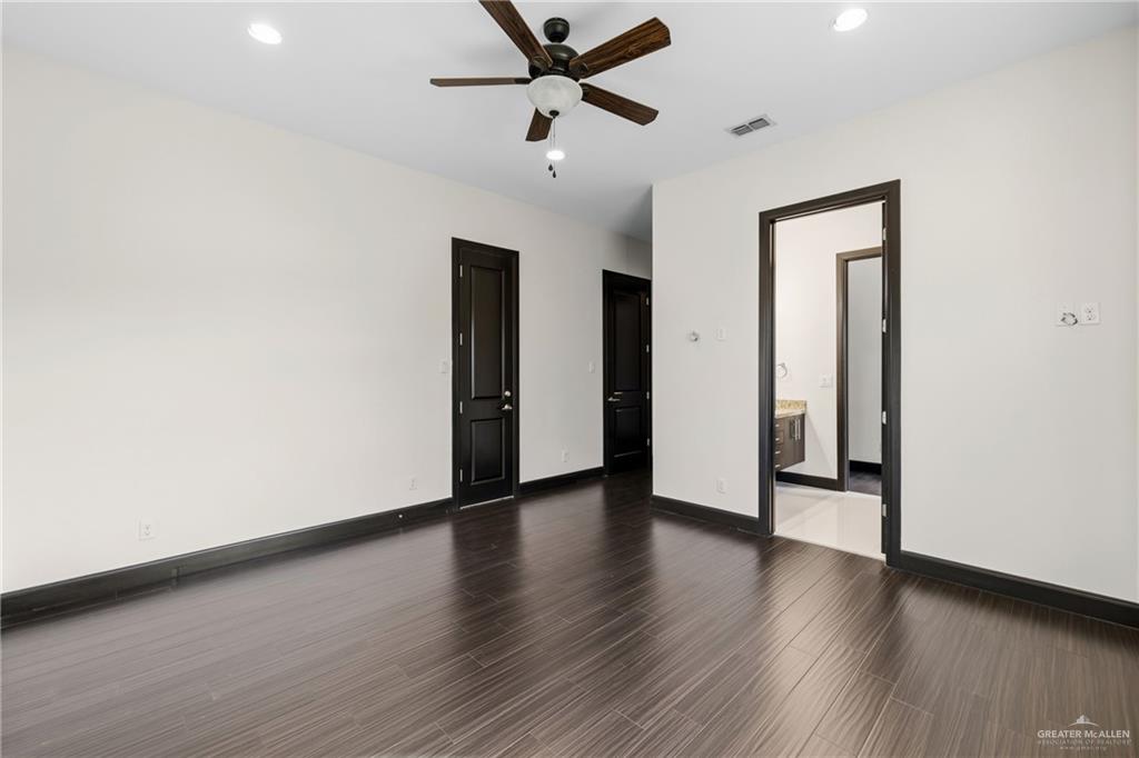 101 East Emory Avenue McAllen, TX 78504 - Photo 14 of 20 a view of an empty room with wooden floor and a ceiling fan