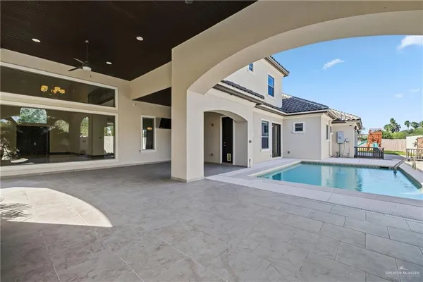 an aerial view of residential houses with outdoor space and ocean view